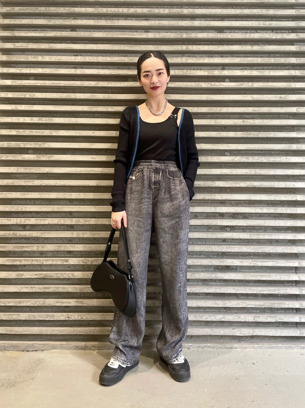 ブラック系のカーディガン/ボレロ、ブラック系のその他パンツ、ブラック系のハンドバッグを着用したレディースの冬コーディネートの1枚目の写真