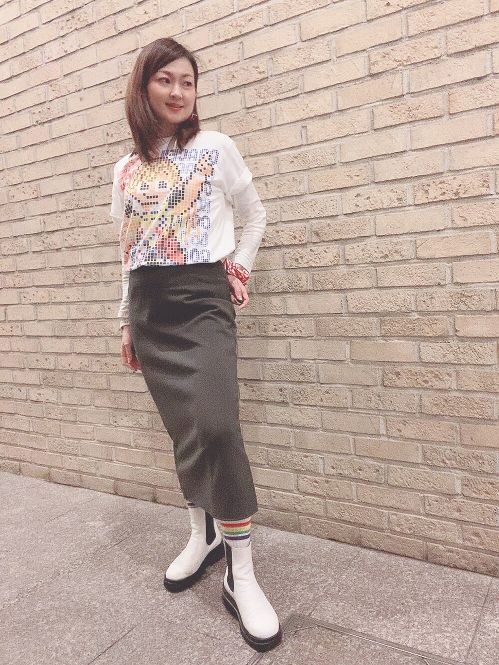 ホワイト系のTシャツ/カットソー、グレー系のスカート、ホワイト系のレインシューズを着用したレディースの春コーディネートの1枚目の写真