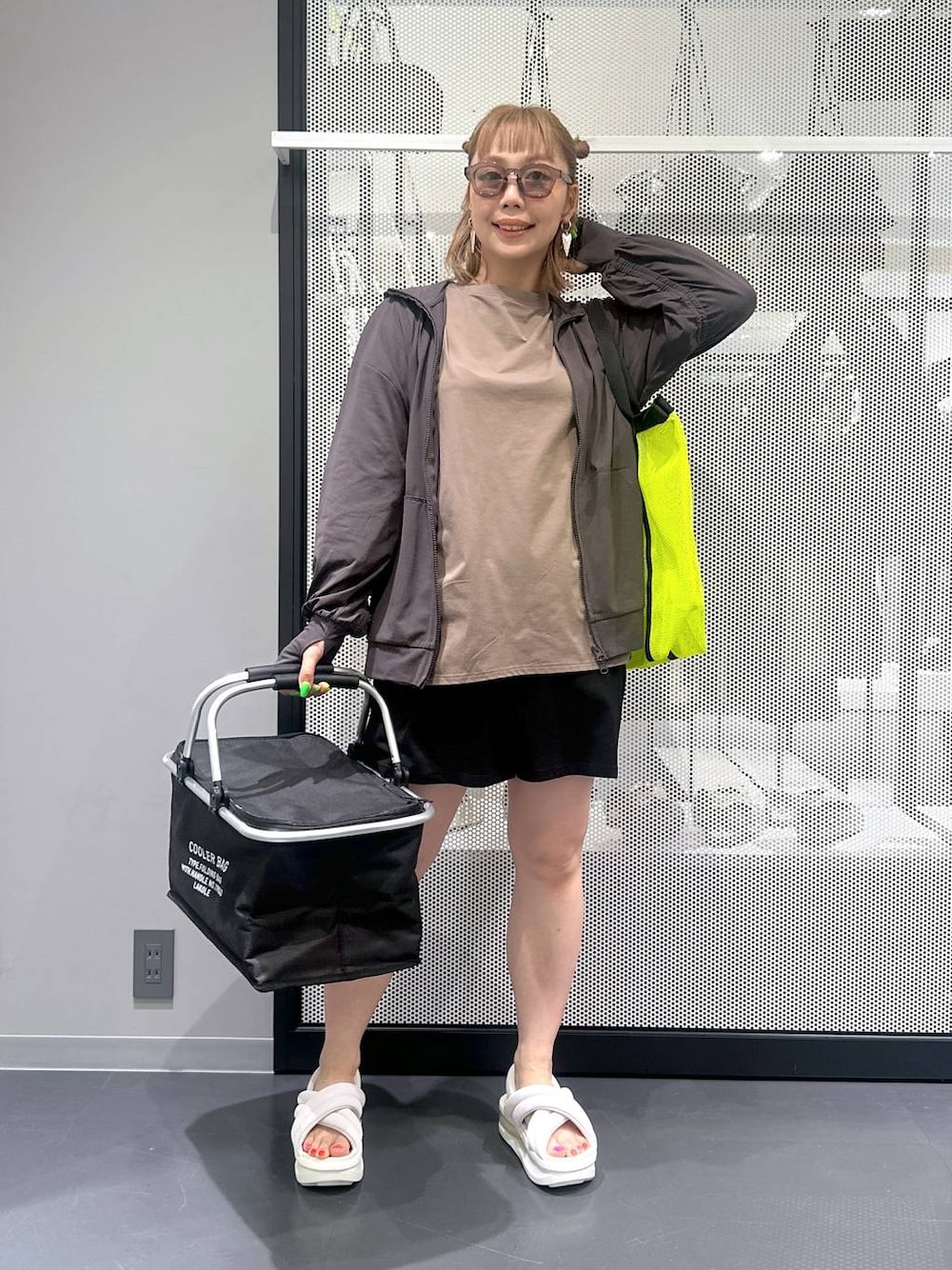 イエロー系のトートバッグ、ブラック系のアウトドアグッズ、その他のピアス(両耳用)を着用したレディースの春コーディネートの1枚目の写真