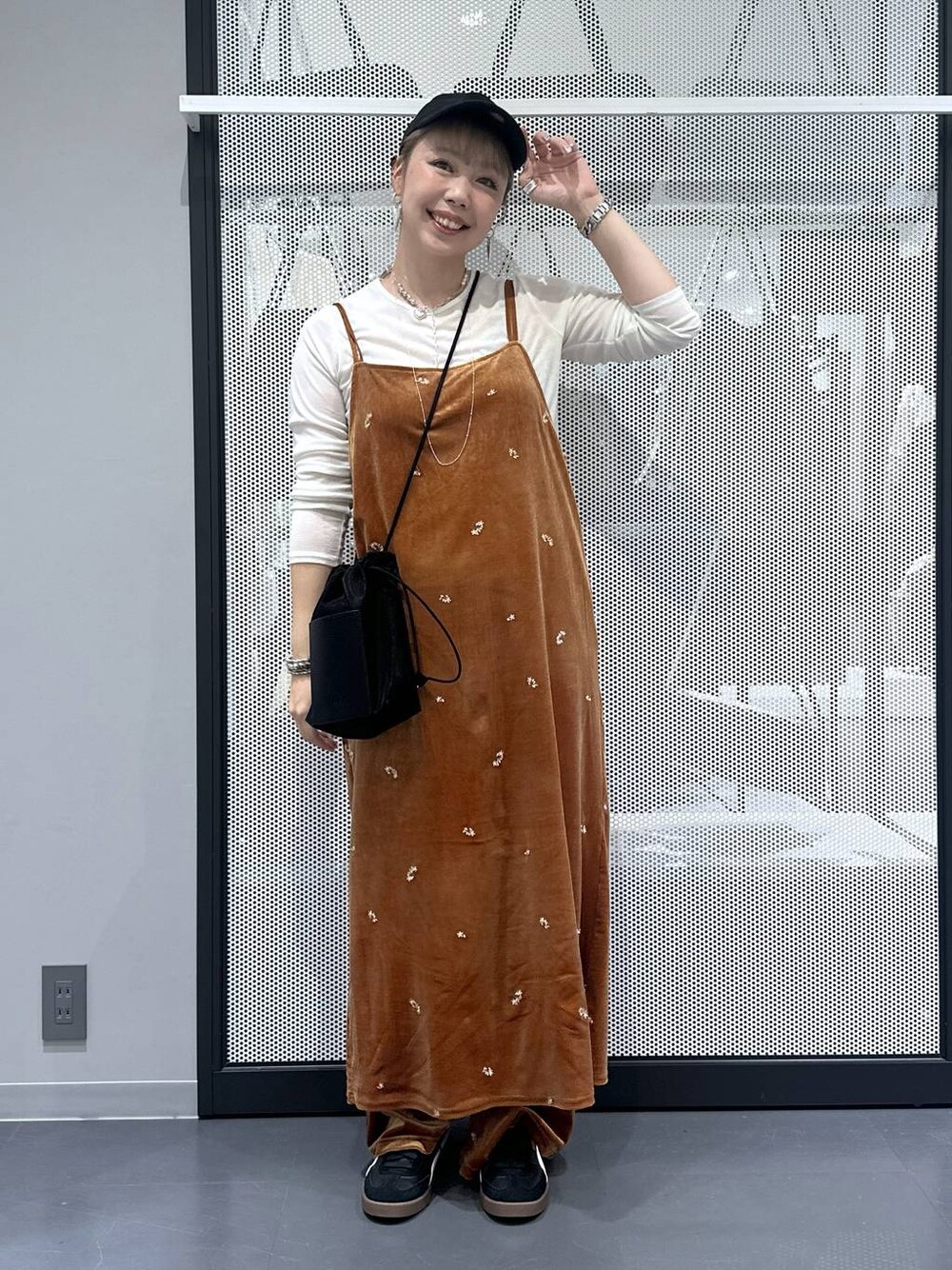 ホワイト系のTシャツ/カットソー、ブラック系のスニーカー、ブラック系のショルダーバッグを着用したレディースの秋コーディネートの1枚目の写真