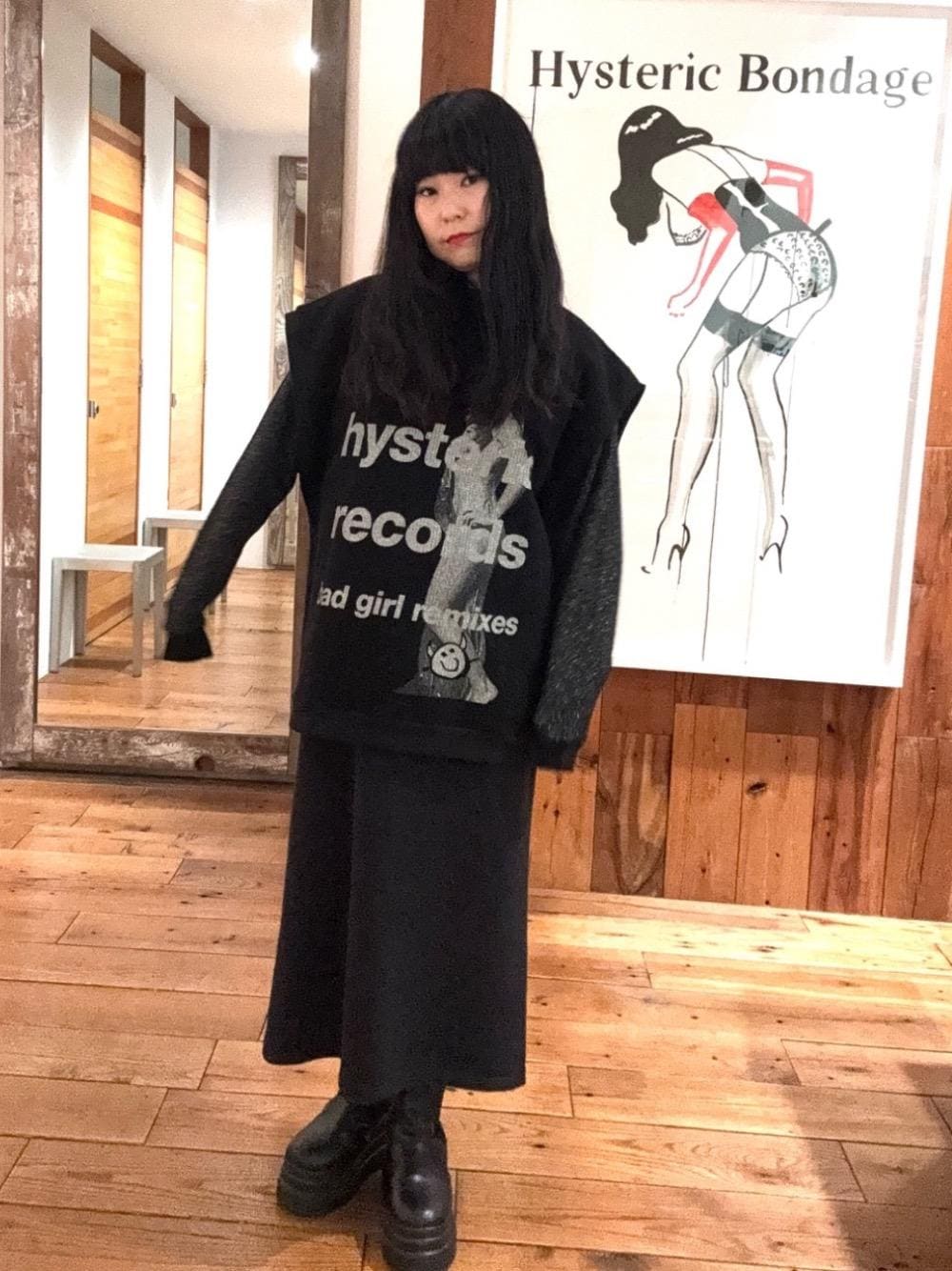 ブラック系のワンピース、ブラック系のスウェット、ブラック系のベストを着用したレディースの秋コーディネートの1枚目の写真