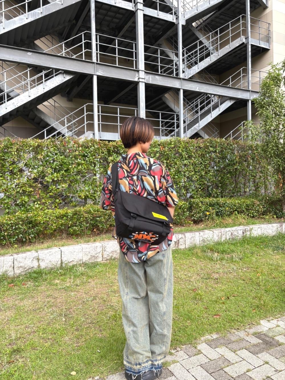 ブラック系のメッセンジャーバッグを着用したレディースの夏コーディネートの1枚目の写真