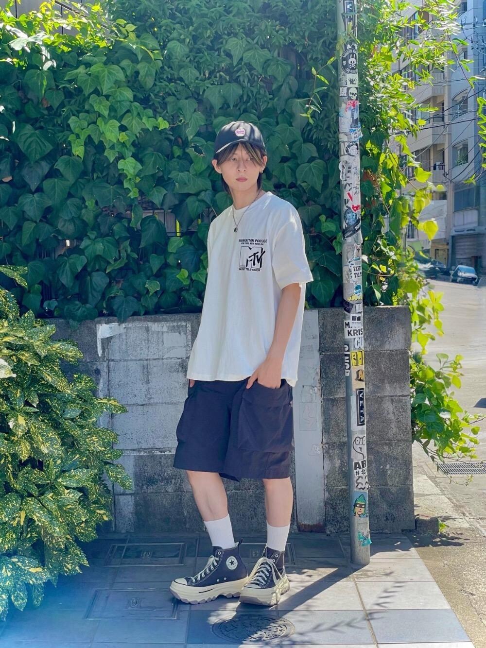 ホワイト系のTシャツ/カットソー、ブラック系のキャップを着用したメンズの夏コーディネートの1枚目の写真