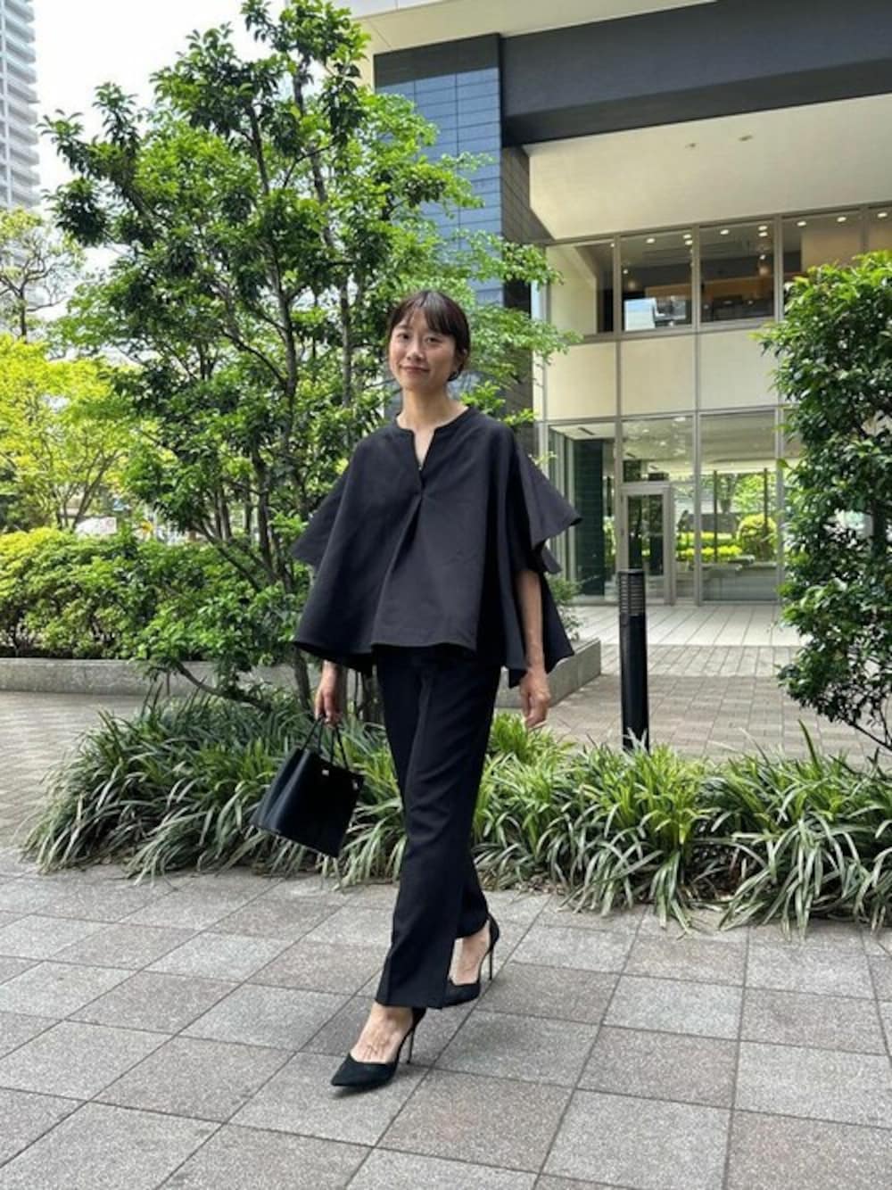 ブラック系のシャツ/ブラウスを着用したレディースの春コーディネートの1枚目の写真