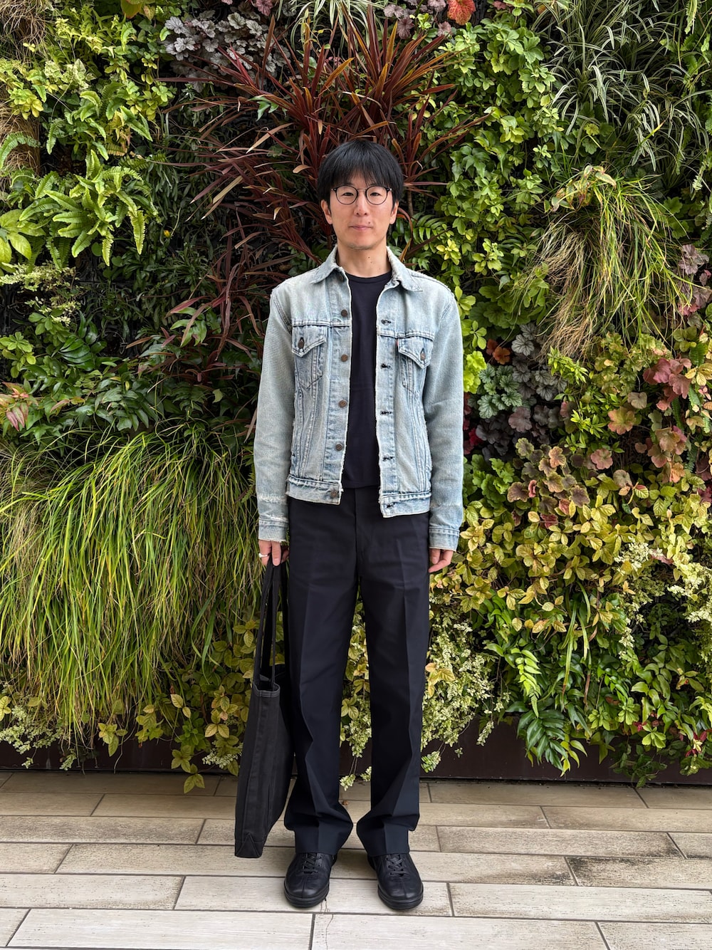 ブルー系のデニムジャケット、ブルー系のチノパンツ、ブラック系のスニーカーを着用したメンズの秋コーディネートの1枚目の写真