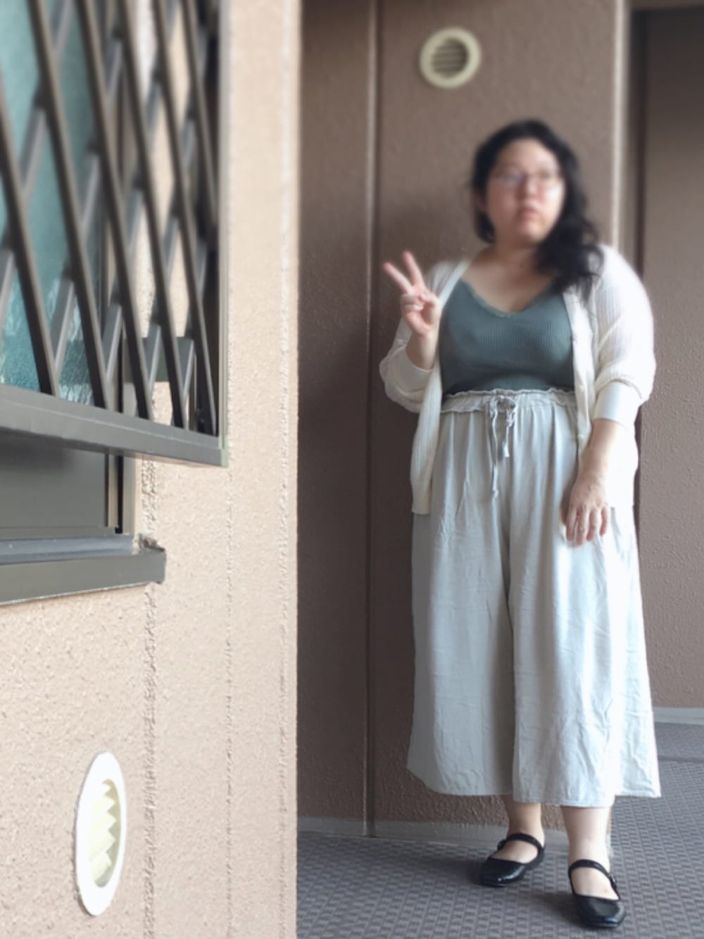 グリーン系のキャミソール、ホワイト系のカーディガン/ボレロ、ベージュ系のその他パンツを着用したレディースの秋コーディネートの1枚目の写真