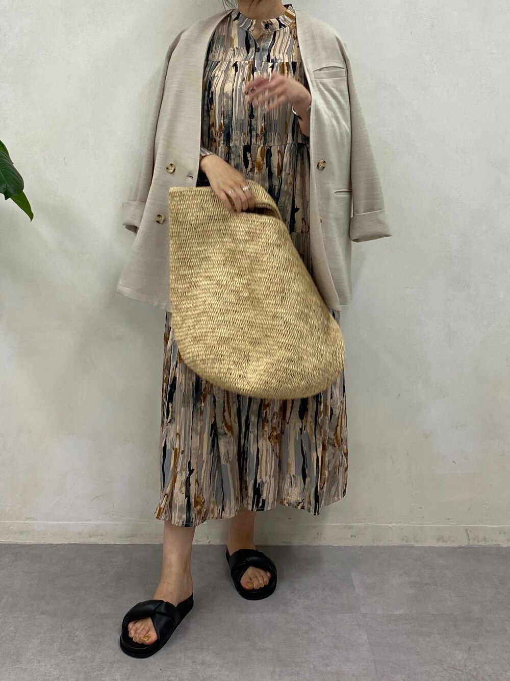 ブラウン系のワンピース、ベージュ系のノーカラージャケット、シルバー系のブレスレットを着用したレディースの春コーディネートの4枚目の写真