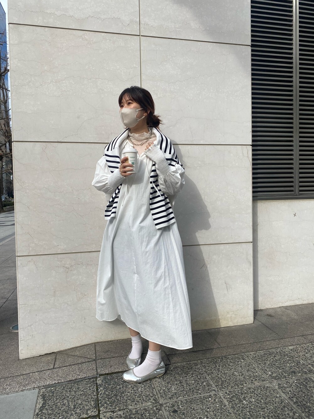 ホワイト系のワンピース、シルバー系のパンプス、ホワイト系のTシャツ/カットソーを着用したレディースの冬コーディネートの2枚目の写真