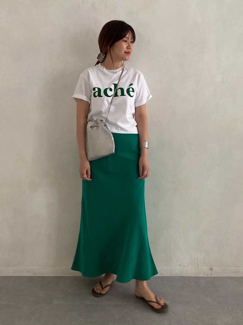 ホワイト系のTシャツ/カットソー、シルバー系のトートバッグ、グリーン系のスカートを着用したレディースの春コーディネートの3枚目の写真