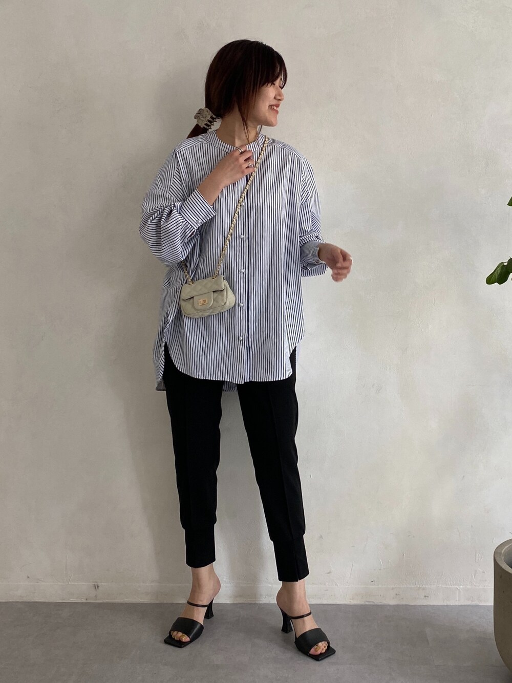ブルー系のシャツ/ブラウス、ブラック系のその他パンツ、ホワイト系のショルダーバッグを着用したレディースの春コーディネートの4枚目の写真