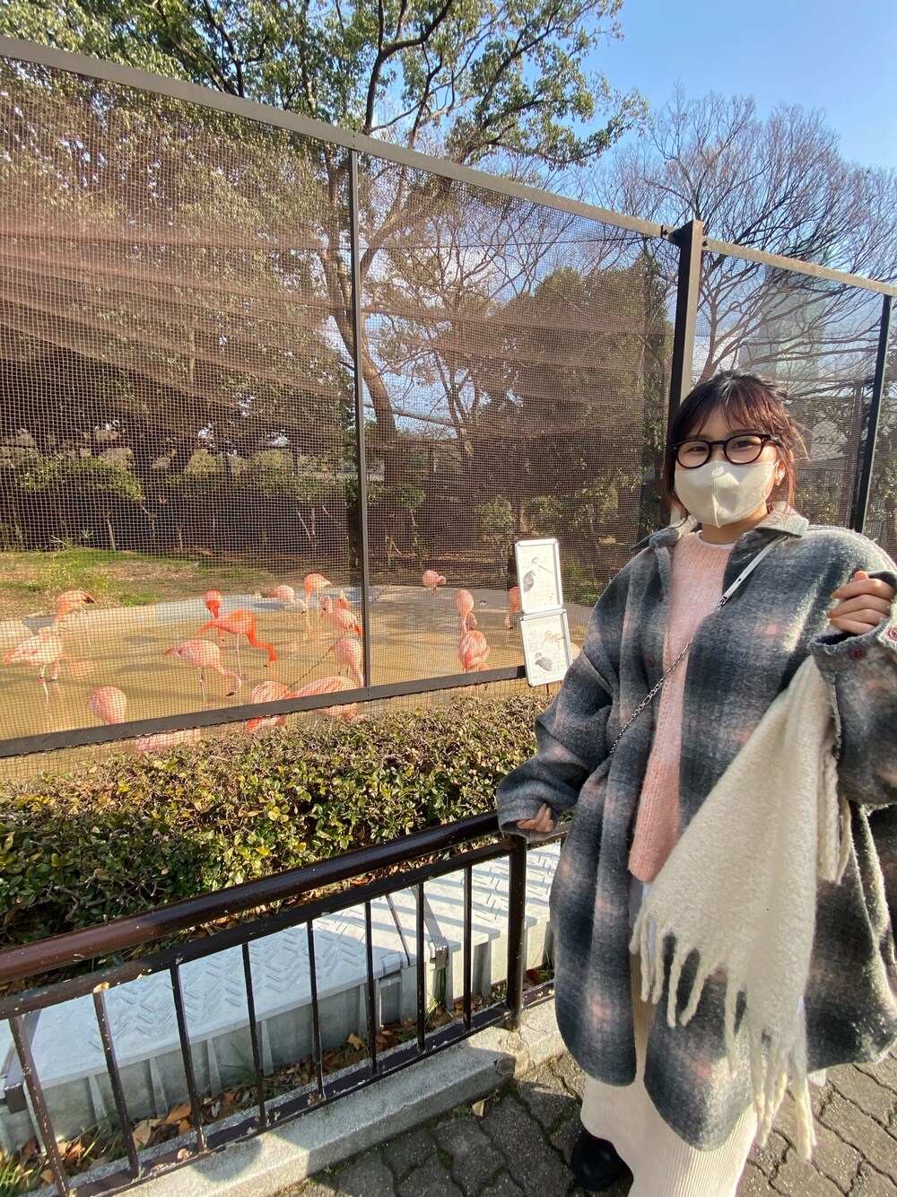 ピンク系のニット/セーター、ホワイト系のスカート、ブラック系のブーツを着用したレディースの冬コーディネートの5枚目の写真