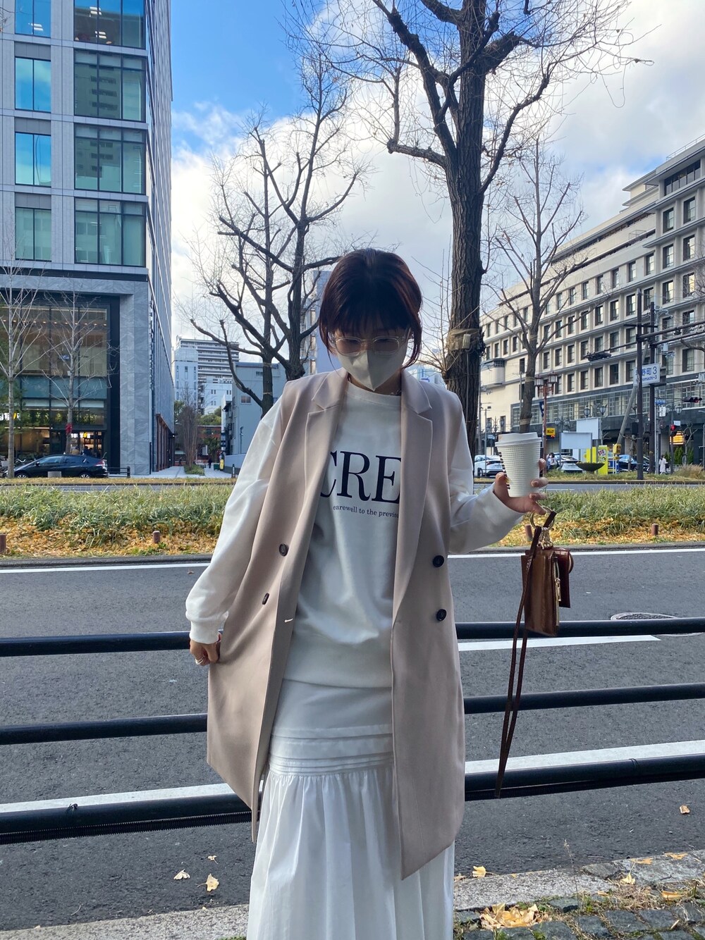 ベージュ系のベスト、ホワイト系のTシャツ/カットソー、ホワイト系のスカートを着用したレディースの冬コーディネートの4枚目の写真