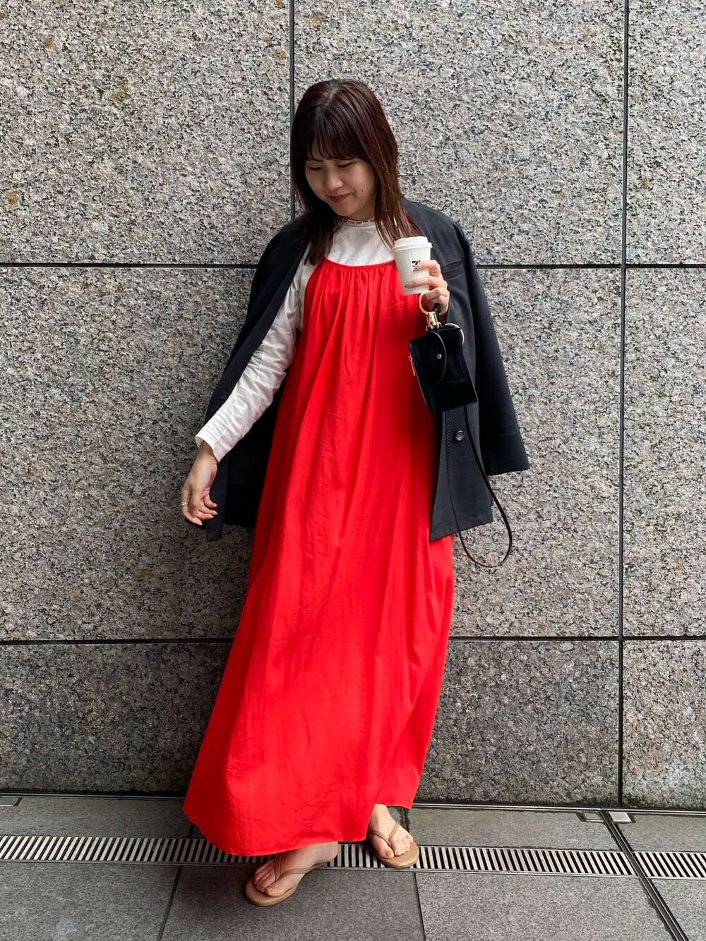 グレー系のノーカラージャケット、レッド系のワンピース/ドレス、ホワイト系のTシャツ/カットソーを着用したレディースの春コーディネートの2枚目の写真