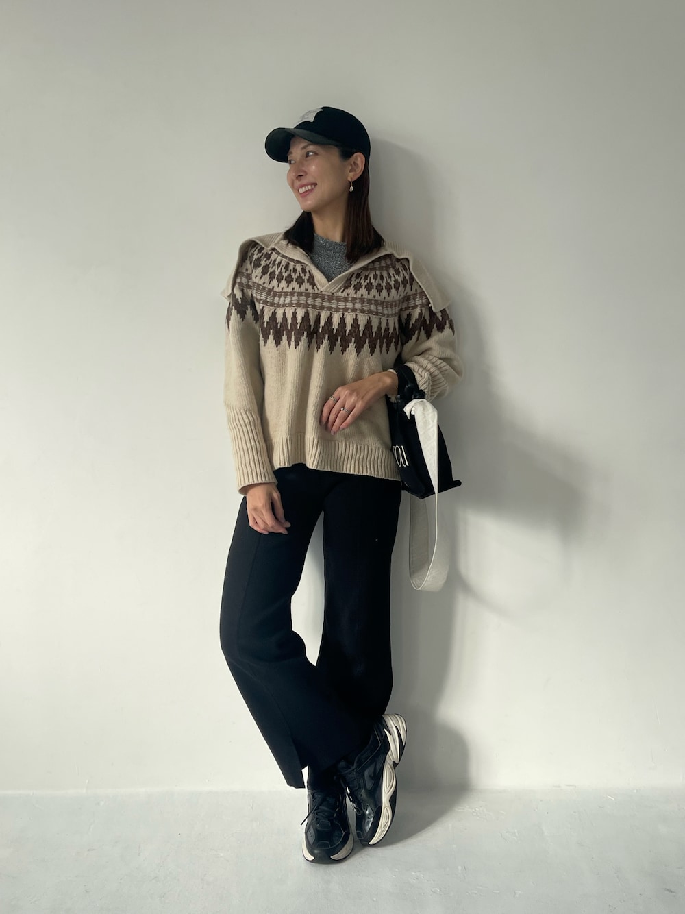 ホワイト系のニット/セーター、ブラック系のその他パンツ、ブラック系のキャップを着用したレディースの冬コーディネートの1枚目の写真