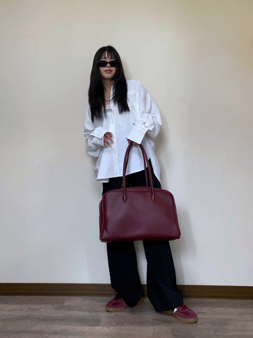 ホワイト系のシャツ/ブラウス、レッド系のボストンバッグ、レッド系のスニーカーを着用したレディースの秋コーディネートの1枚目の写真