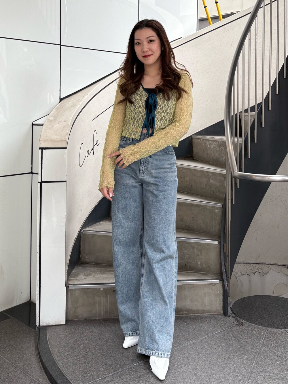 ホワイト系のパンプス、ブルー系のデニムパンツ、イエロー系のカーディガン/ボレロを着用したレディースの春コーディネートの1枚目の写真
