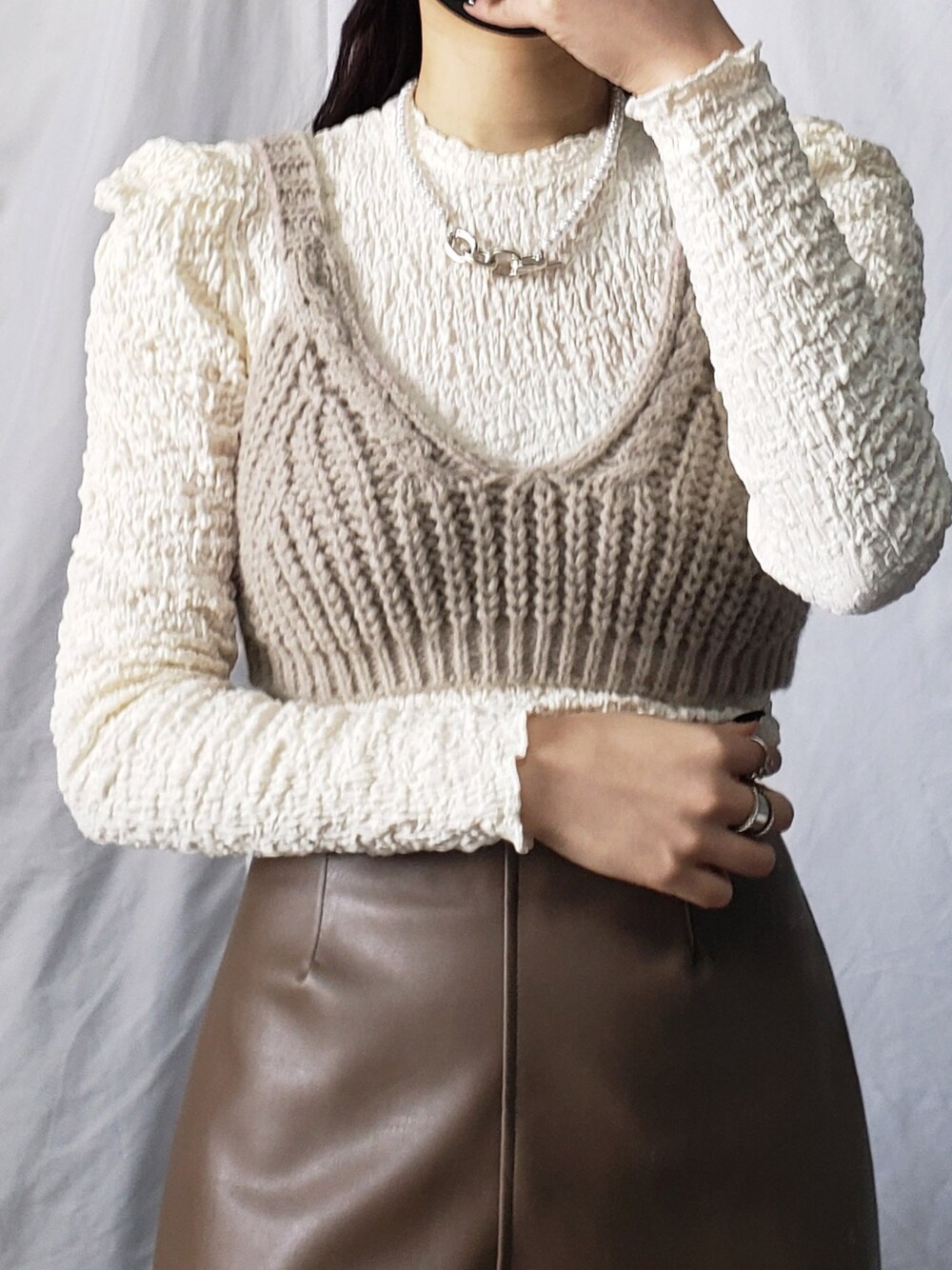 ホワイト系のスラックス、ブラック系のショルダーバッグ、ブルー系のTシャツ/カットソーを着用したレディースの冬コーディネートの5枚目の写真