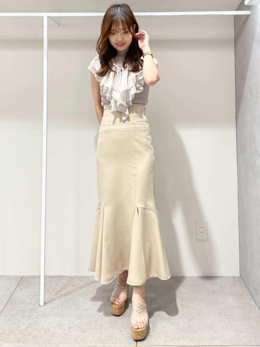 ベージュ系のスカート、その他のサンダル、ピンク系のニット/セーターを着用したレディースの春コーディネートの1枚目の写真