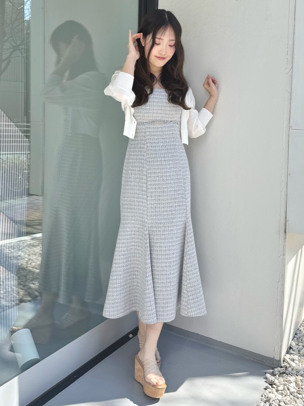 グレー系のワンピース、ホワイト系のカーディガン/ボレロ、その他のサンダルを着用したレディースの春コーディネートの1枚目の写真