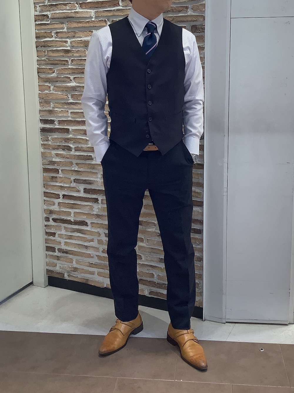 パープル系のビジネスシャツ、ブルー系のネクタイを着用したメンズの冬コーディネートの1枚目の写真