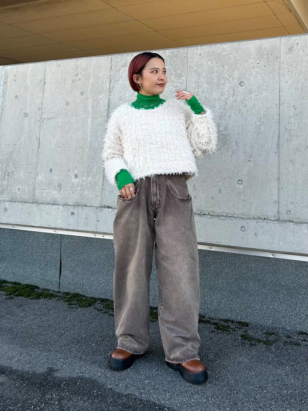 ホワイト系のニット/セーター、ブラウン系のデニムパンツを着用したレディースの秋コーディネートの1枚目の写真