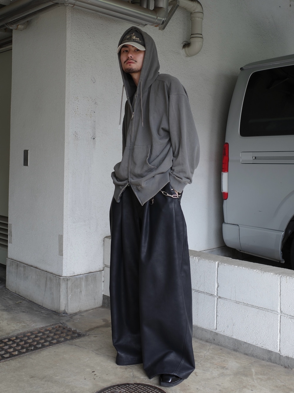 グレー系のパーカー、ブラック系のその他パンツを着用したメンズの秋コーディネートの1枚目の写真