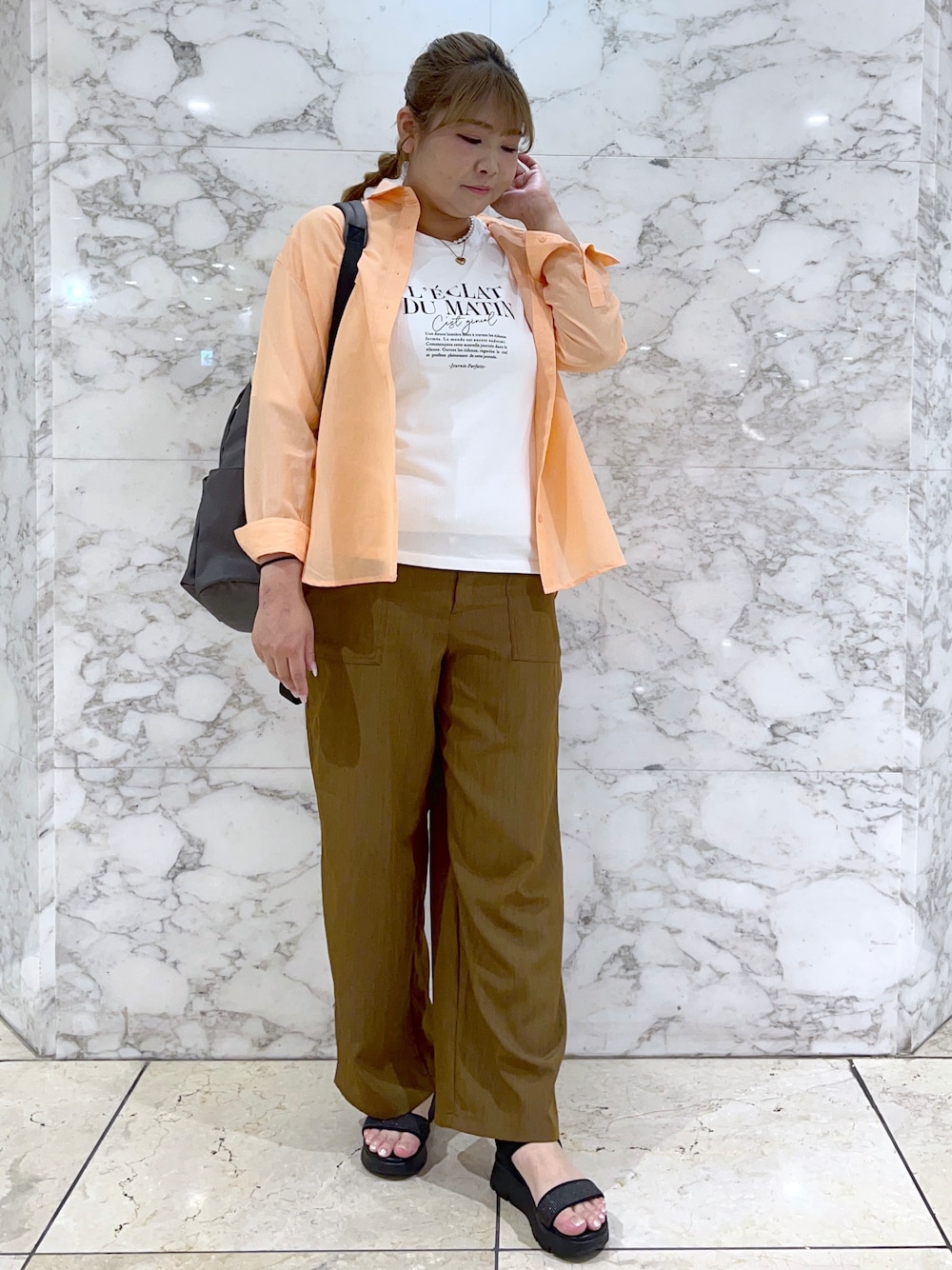 オレンジ系のシャツ/ブラウス、ホワイト系のTシャツ/カットソー、イエロー系のその他パンツを着用したレディースの春コーディネートの1枚目の写真