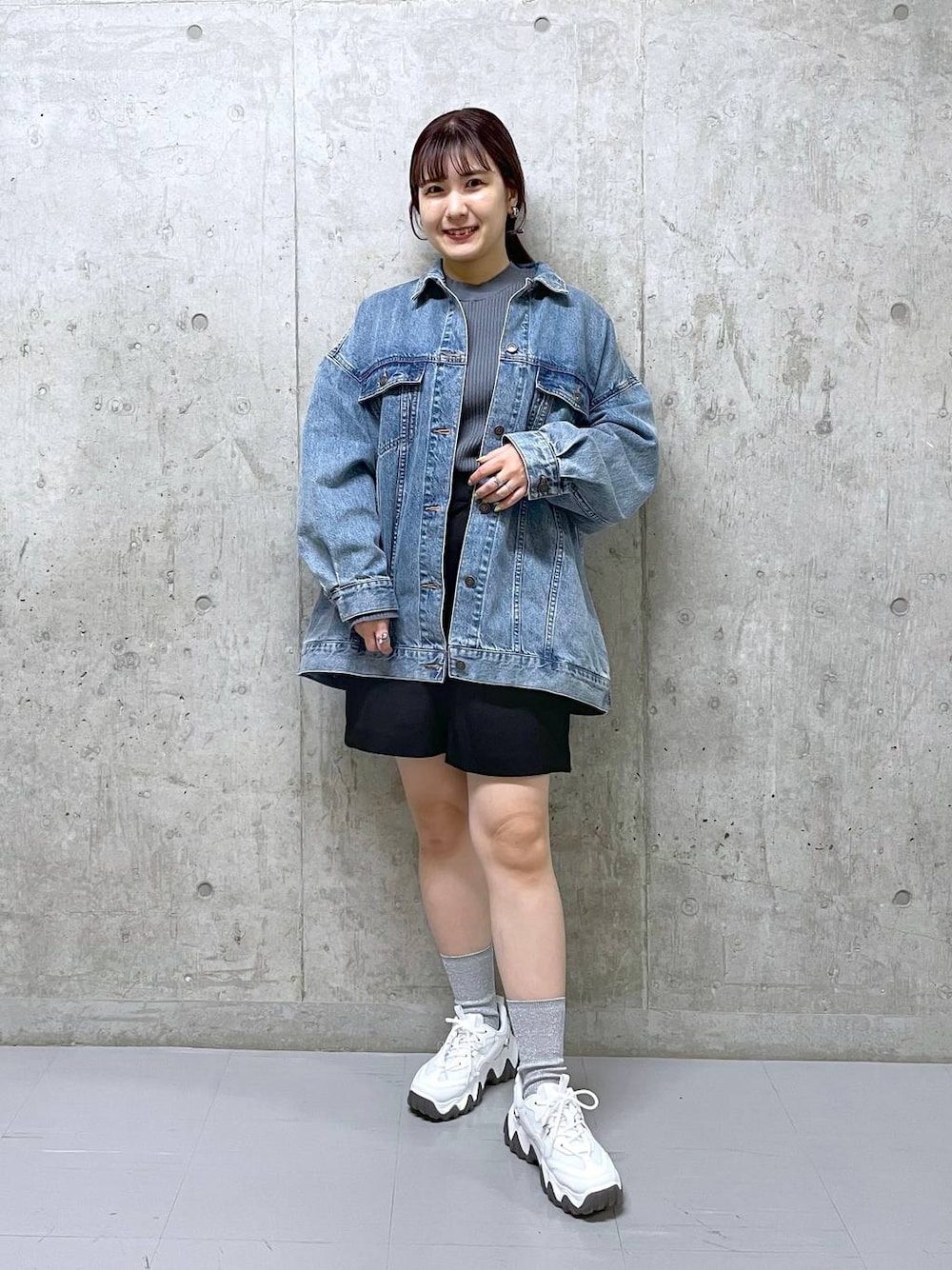 ブラック系のその他パンツ、ブルー系のデニムジャケット、グレー系のニット/セーターを着用したレディースの春コーディネートの1枚目の写真