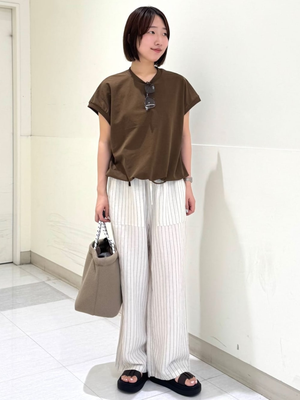ブラウン系のサンダル、その他のその他パンツ、ブラウン系のTシャツ/カットソーを着用したレディースの夏コーディネートの1枚目の写真