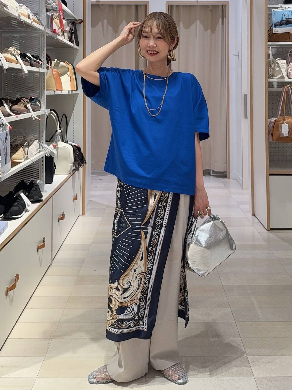シルバー系のショルダーバッグ、ホワイト系のその他パンツ、ブルー系のTシャツ/カットソーを着用したレディースの夏コーディネートの1枚目の写真