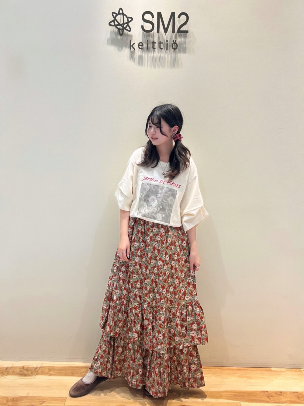 レッド系のスカート、ホワイト系のTシャツ/カットソー、ブラウン系のドレスシューズを着用したレディースの夏コーディネートの1枚目の写真