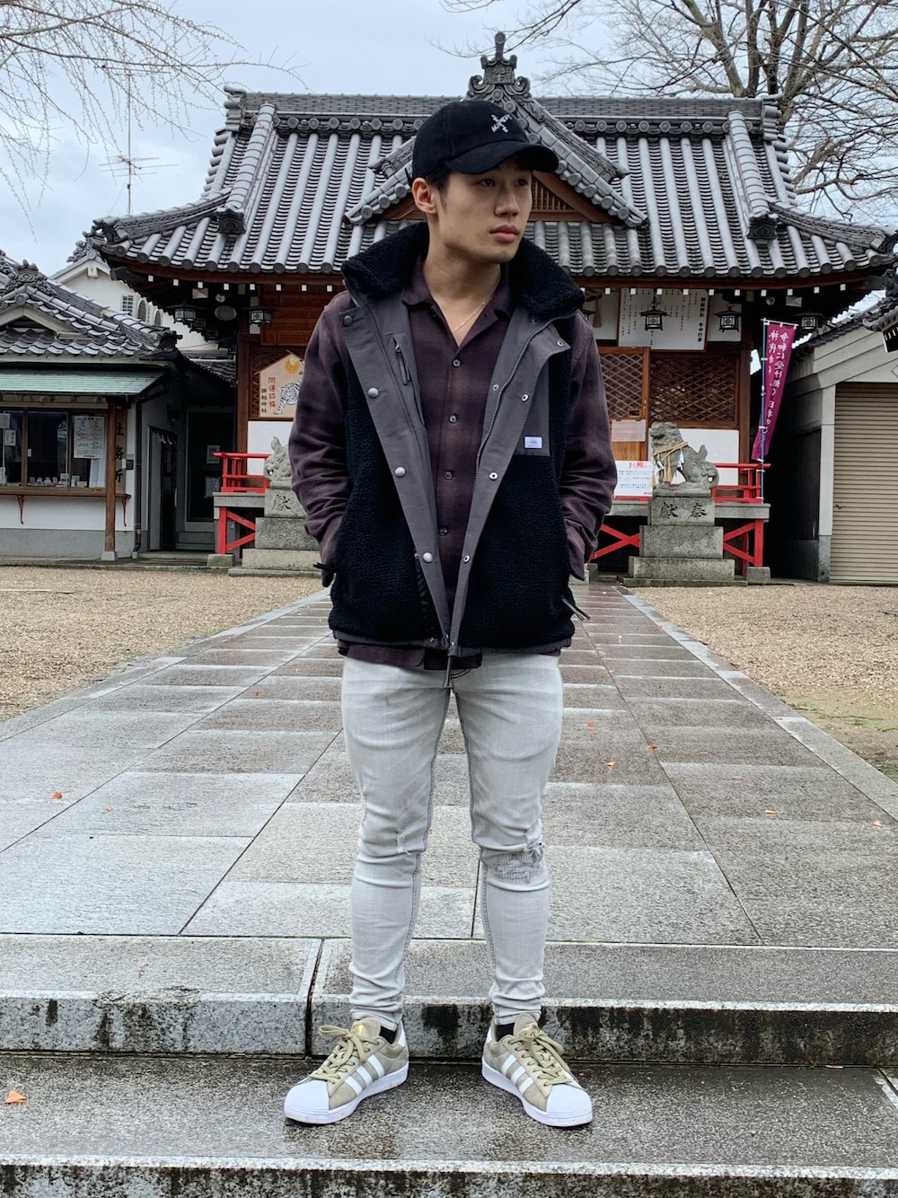 ブラウン系のシャツ/ブラウス、ブラック系のベスト、グレー系のデニムパンツを着用したメンズの春コーディネートの1枚目の写真