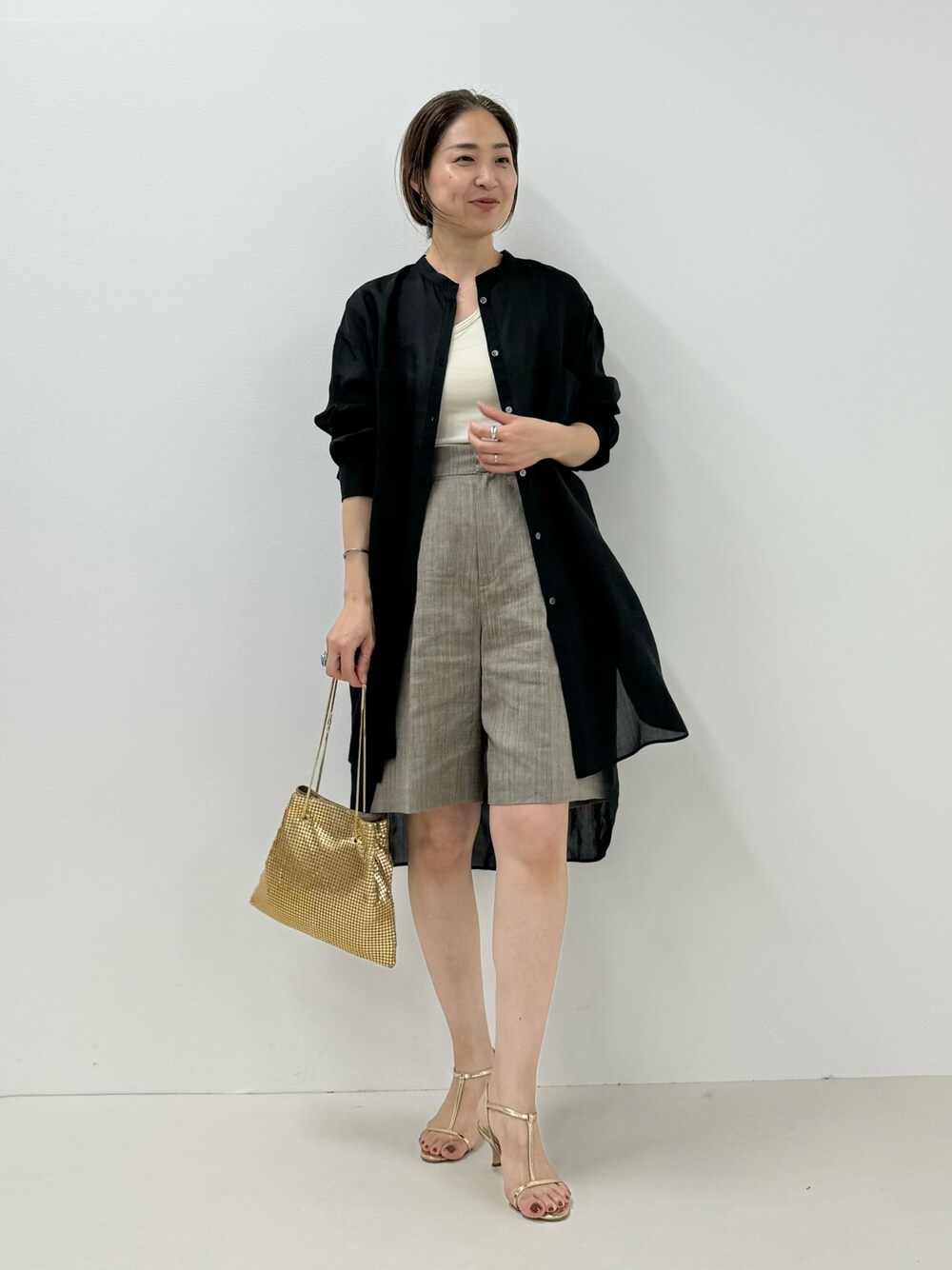 「ロングシャツ、シアートップス、シアーシャツ、ショートパンツ、メタリックバッグ、ゴールドアクセ、ゴールド、レイヤードスタイル、きれいめカジュアル、シンプルコーデ、大人女子、シャツスタイル、へザー、ヘアクリップ」｜「NOLLEY’Sのシアーロングシャツ（シャツ/ブラウス、ブラック系）」を使った、ISHIDAさん（レディース・158cm）の春コーディネートの1枚目の写真