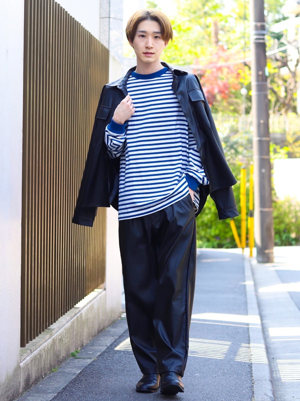 ブラック系のセットアップ、ブルー系のTシャツ/カットソー、ブラック系のブーツを着用したメンズの春コーディネートの1枚目の写真