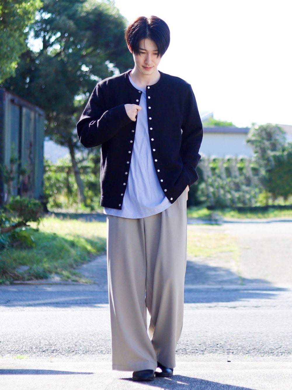 ブラック系のカーディガン/ボレロ、ブルー系のTシャツ/カットソー、ベージュ系のセットアップを着用したメンズの秋コーディネートの1枚目の写真