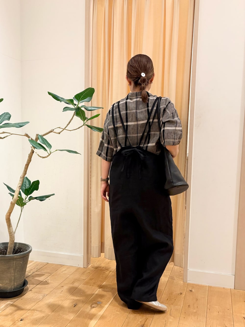 ブラック系のサロペット/オーバーオール、ブラック系のシャツ/ブラウス、シルバー系のスリッポンを着用したレディースの春コーディネートの2枚目の写真