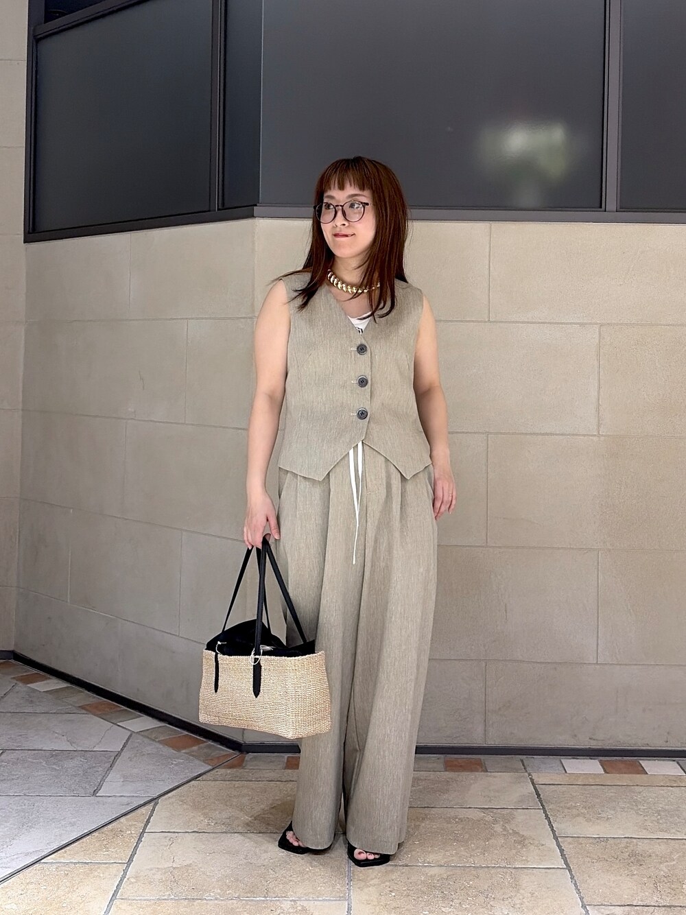 ベージュ系のベスト、ホワイト系のタンクトップ、ベージュ系のその他パンツを着用したレディースの春コーディネートの7枚目の写真