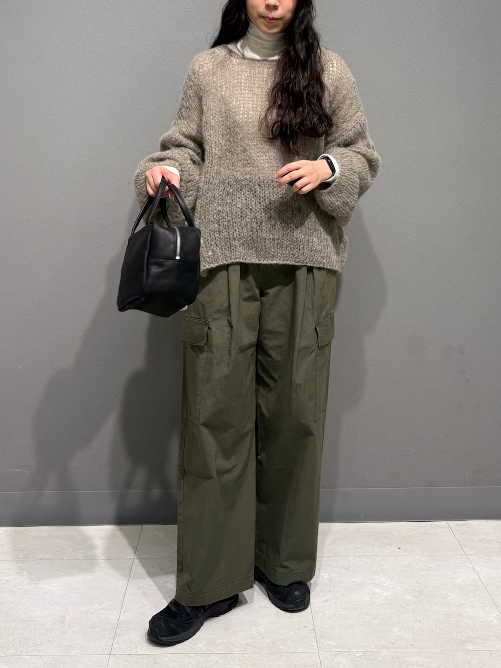 グレー系のニット/セーター、ホワイト系のTシャツ/カットソー、グリーン系のその他パンツを着用したレディースの秋コーディネートの6枚目の写真