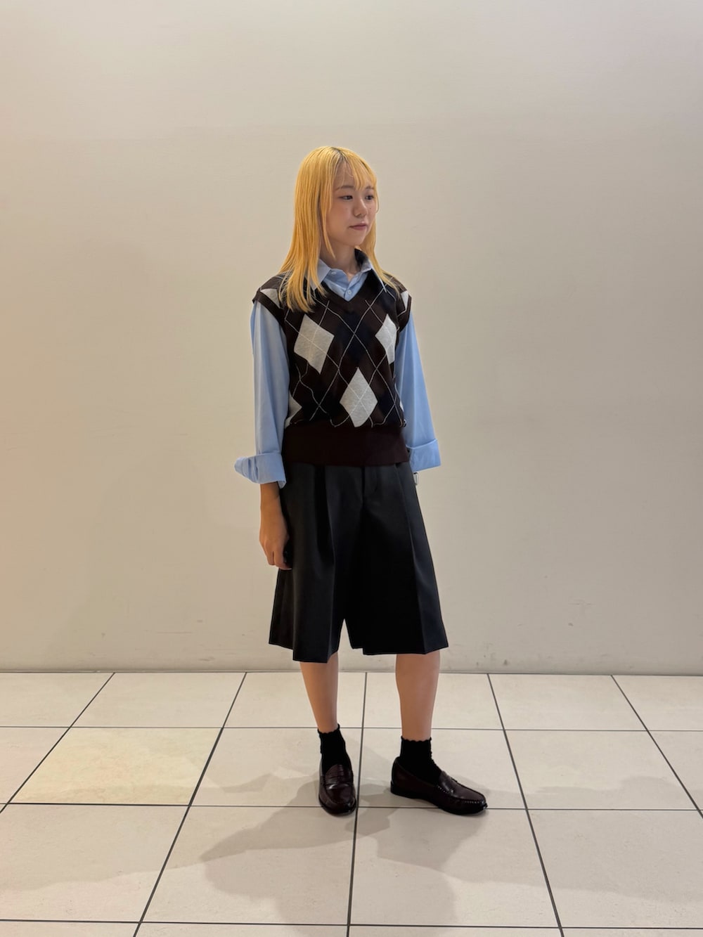 ブラウン系のベスト、ブルー系のシャツ/ブラウス、グレー系のその他パンツを着用したレディースの秋コーディネートの4枚目の写真
