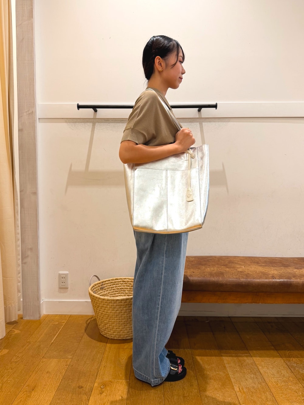 ベージュ系のニット/セーター、ブルー系のデニムパンツ、ブラック系のサンダルを着用したレディースの夏コーディネートの2枚目の写真