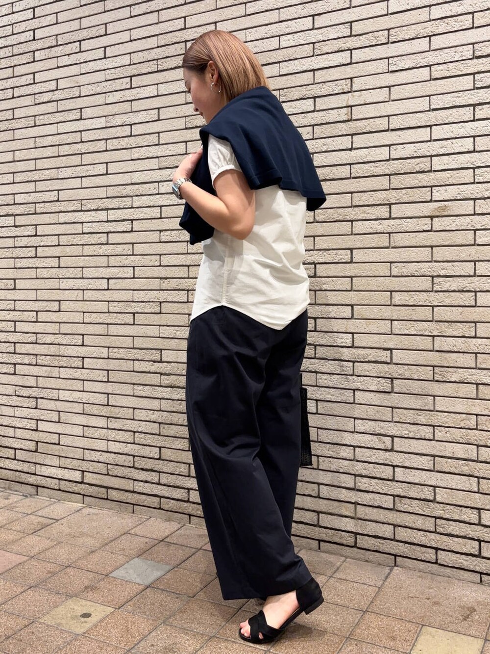 ブラック系のサンダル、ブルー系のその他パンツ、ホワイト系のタンクトップを着用したレディースの春コーディネートの7枚目の写真