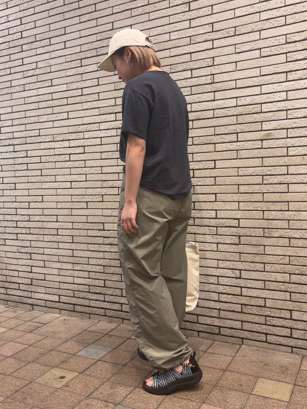 パープル系のサンダル、ベージュ系のその他パンツ、グレー系のTシャツ/カットソーを着用したレディースの春コーディネートの3枚目の写真