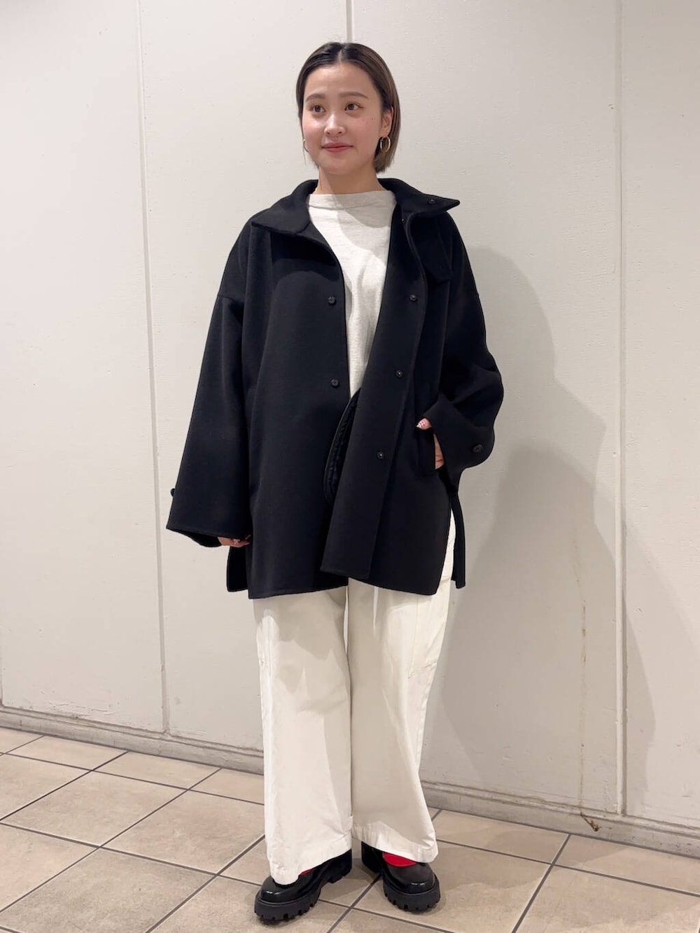 ブラック系のその他シューズ、ホワイト系のその他パンツ、ベージュ系のTシャツ/カットソーを着用したレディースの冬コーディネートの2枚目の写真