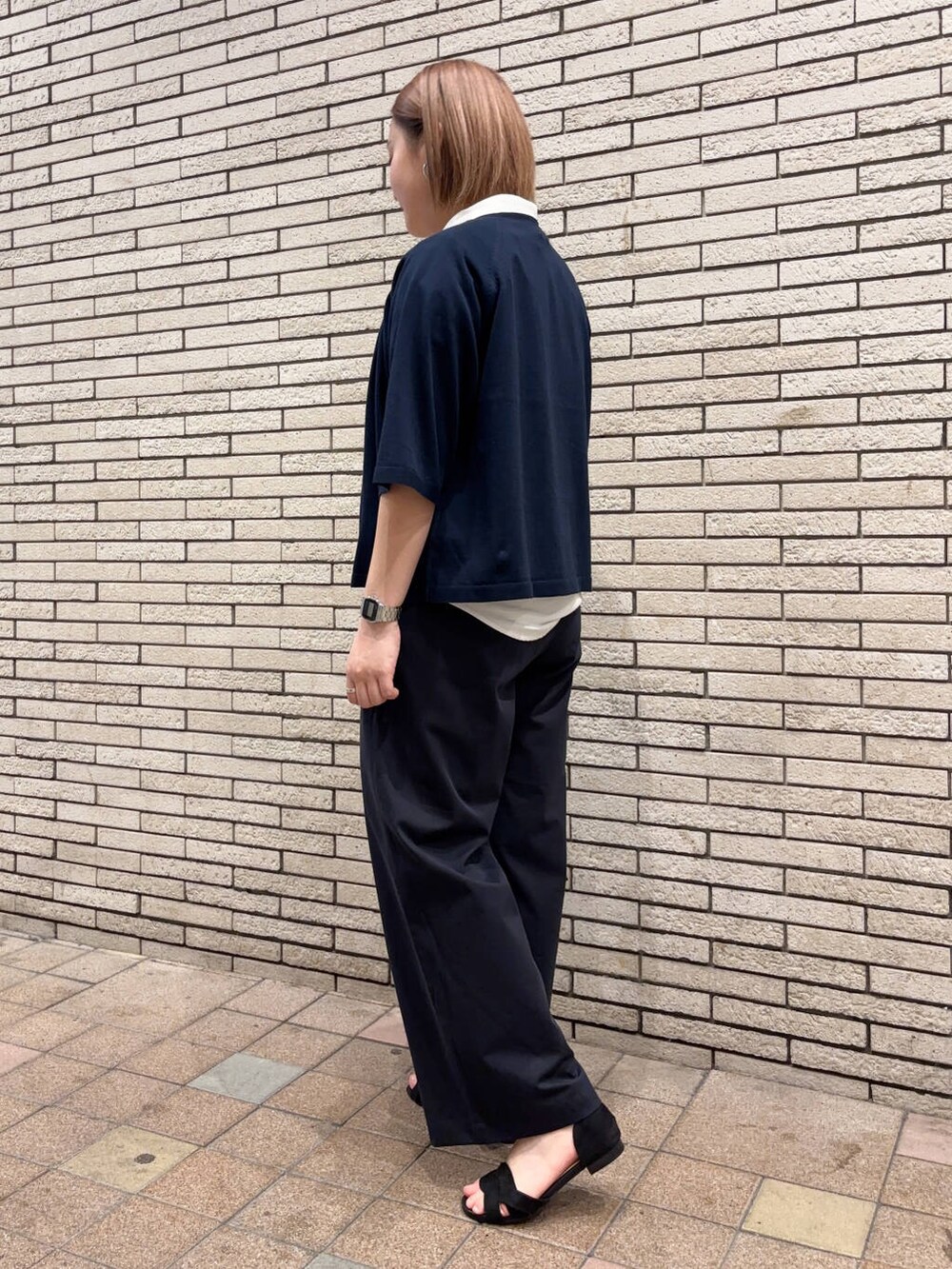 ブラック系のサンダル、ブルー系のその他パンツ、ホワイト系のタンクトップを着用したレディースの春コーディネートの3枚目の写真