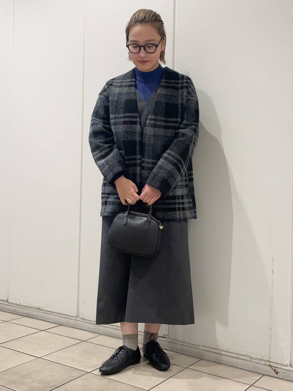 ブラック系のその他シューズ、ブラック系のショルダーバッグ、グレー系のワンピースを着用したレディースの秋コーディネートの2枚目の写真