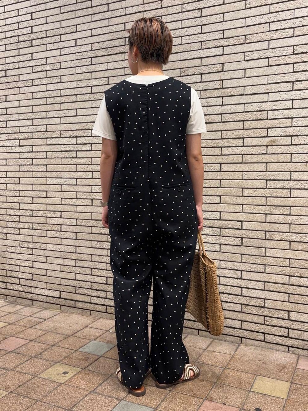 ベージュ系のトートバッグ、ブラック系のサロペット/オーバーオール、ブラウン系のサンダルを着用したレディースの夏コーディネートの4枚目の写真