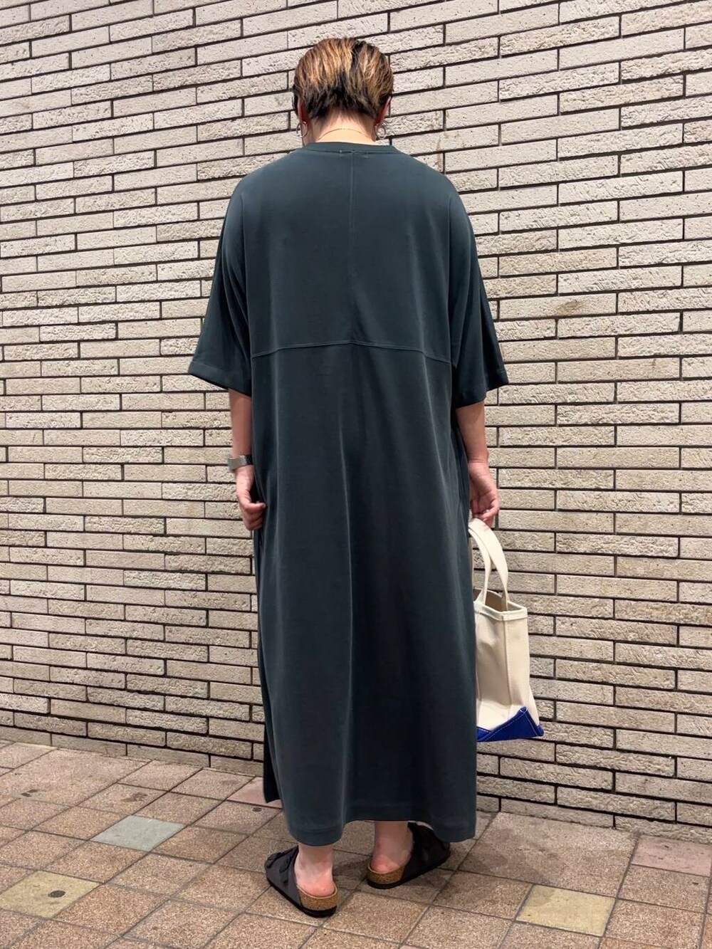 グレー系のサンダル、グリーン系のワンピースを着用したレディースの夏コーディネートの4枚目の写真