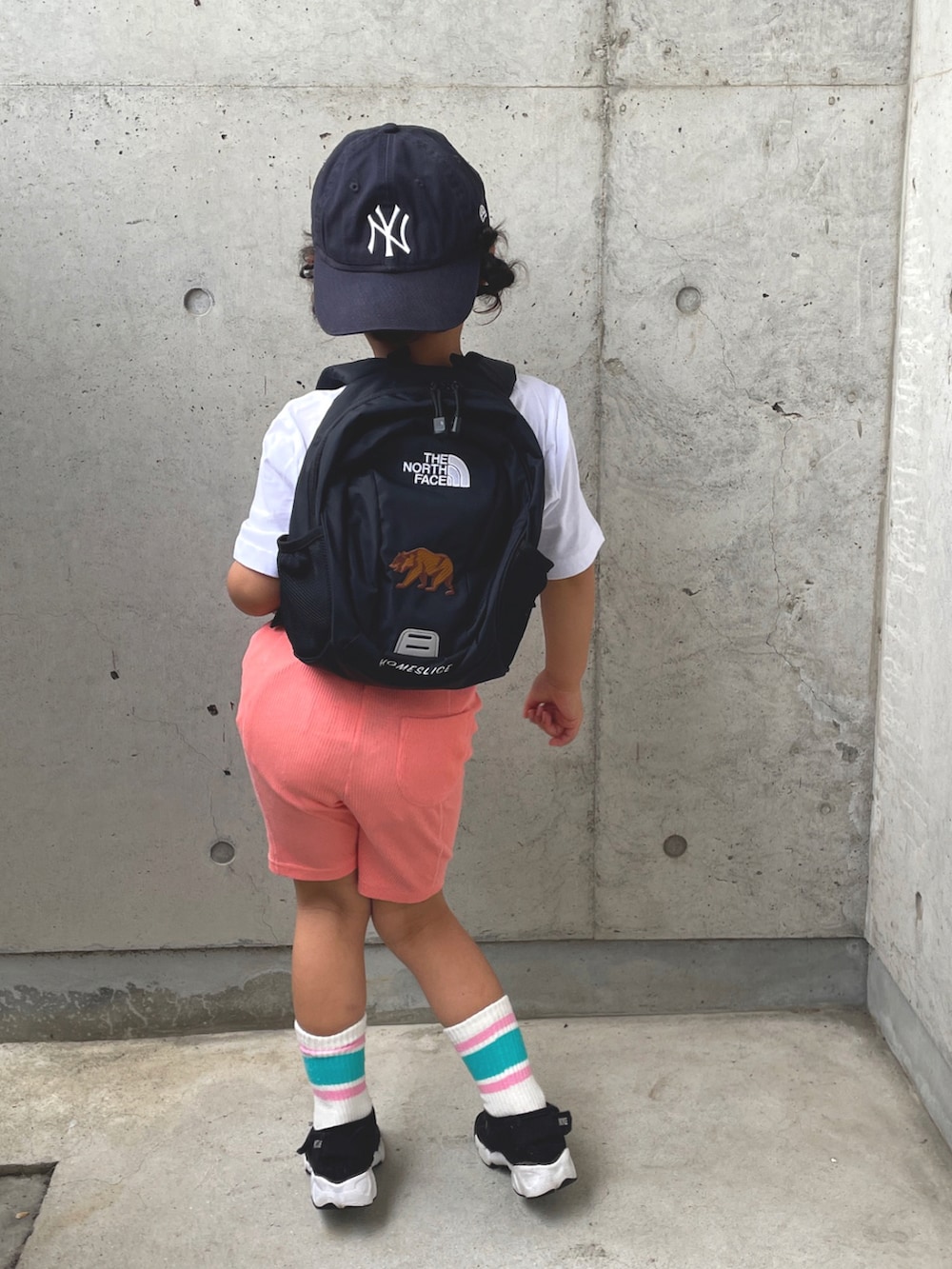 ホワイト系のTシャツ/カットソー、ブラック系のバックパック/リュック、ブラック系のサンダルを着用したキッズの春コーディネートの5枚目の写真