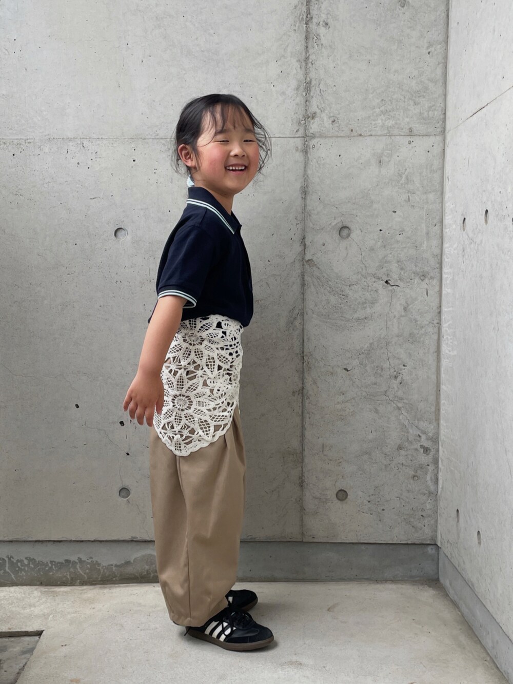 ブルー系のポロシャツ、イエロー系のその他パンツ、ブラック系のスニーカーを着用したキッズの春コーディネートの3枚目の写真