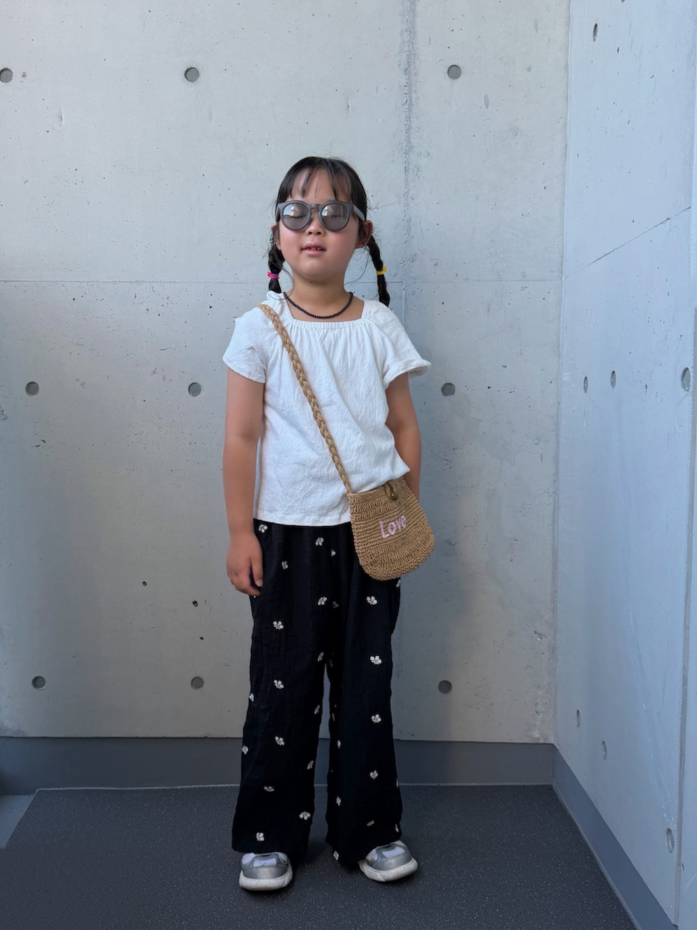 ブラック系のその他パンツ、ベージュ系のショルダーバッグ、シルバー系のスニーカーを着用したキッズの夏コーディネートの5枚目の写真
